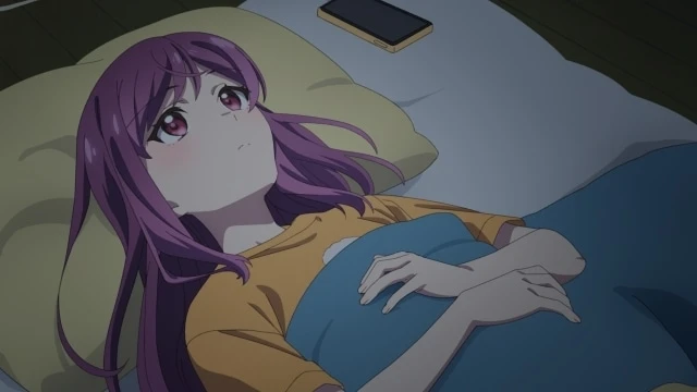 Futami, la protagonista del anime Egao no Taenai Shokuba desu, yace en la cama mirando al techo mientras reflexiona sobre su trabajo en el episodio 2.